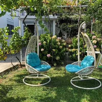 two chairs sitting in the grass in a garden at Lavender Vacation Home, Bar in Bar