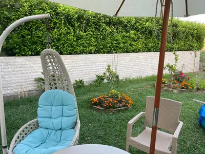 two chairs and an umbrella in a yard at Lavender Vacation Home, Bar in Bar