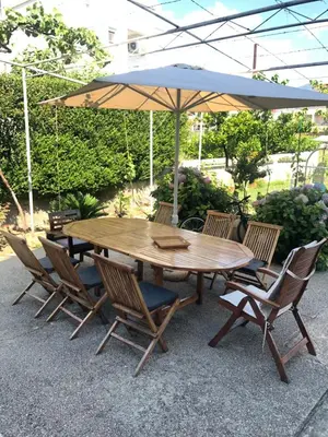 a wooden table and chairs with an umbrella at Lavender Vacation Home, Bar in Bar