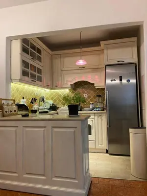 a kitchen with white cabinets and a stainless steel refrigerator at Lavender Vacation Home, Bar in Bar