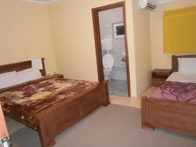 a hotel room with two beds and a bathroom at Vila Patria in Podgorica