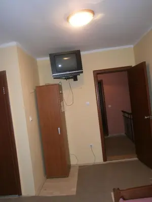 a room with a flat screen tv on the ceiling at Vila Patria in Podgorica