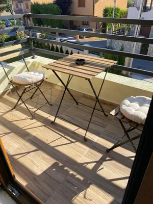 a wooden table and two chairs on a balcony at Apart 31 in Cetinje