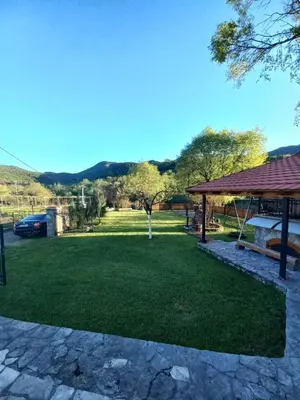 a yard with a gazebo and green grass at T&A Apartment in Rijeka Crnojevića