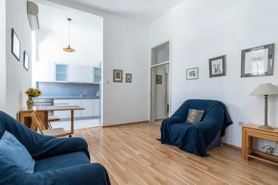 a living room with two blue chairs and a table at CENTRAL CATHEDRAL APARTMENT in Kotor