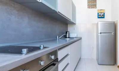 a kitchen with a sink and a refrigerator at CENTRAL CATHEDRAL APARTMENT in Kotor