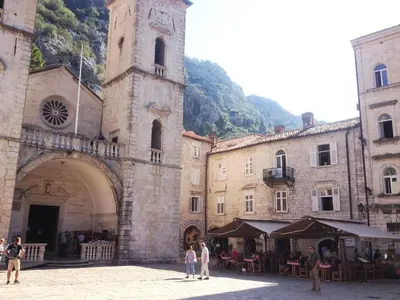a group of people standing in a courtyard next to a building at CENTRAL CATHEDRAL APARTMENT in Kotor