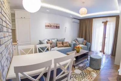 a living room with a table and chairs and a couch at Villa Marco Polo in Budva