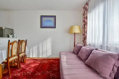 a living room with a purple couch and a table at Apartment Ruzica in Sveti Stefan