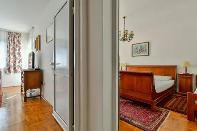 a bedroom with a bed and a sliding glass door at Apartment Ruzica in Sveti Stefan
