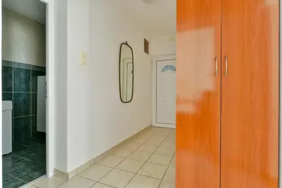a room with a hallway with a mirror and a door at Apartment Ruzica in Sveti Stefan