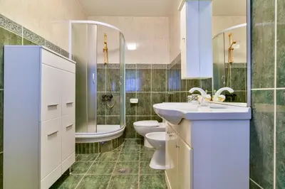 a bathroom with a sink and a toilet and a tub at Apartment Ruzica in Sveti Stefan