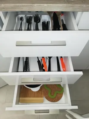 a white cabinet filled with lots of cooking utensils at Luna apartment in Petrovac na Moru