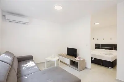 a living room with a couch and a bed at Luna apartment in Petrovac na Moru