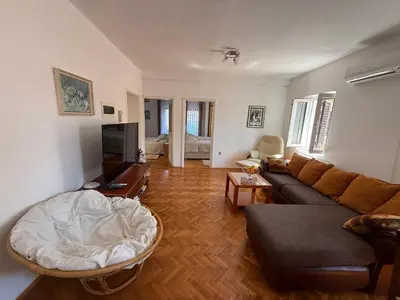 a living room with a couch and a tv at Apartments Aleksić Old Town in Budva