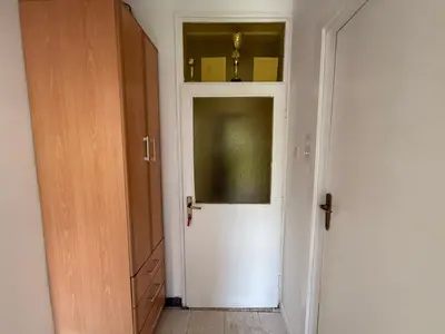 a hallway with a white door and a closet at Apartments Aleksić Old Town in Budva