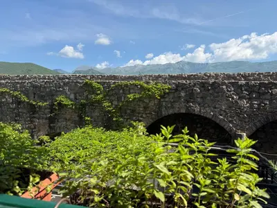 an old stone bridge with two arches at Apartments Aleksić Old Town in Budva
