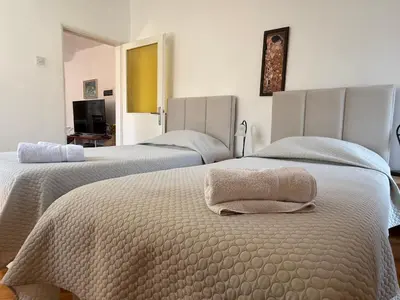 a bedroom with two beds with towels on them at Apartments Aleksić Old Town in Budva