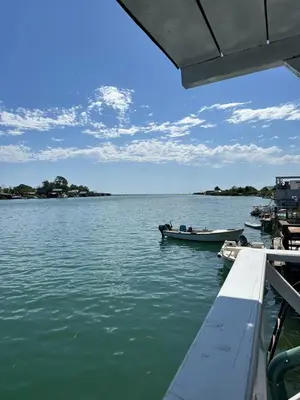 a boat is docked on a large body of water at Stella Marina in Pržno