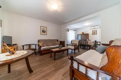 a living room filled with furniture and a table at House Gorica in Bar
