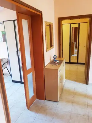 a room with a counter and a room with doors at Apartment Danijela in Budva