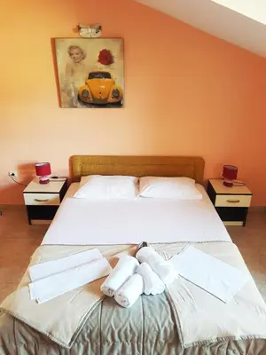 a bedroom with a bed with towels on it at Apartment Danijela in Budva