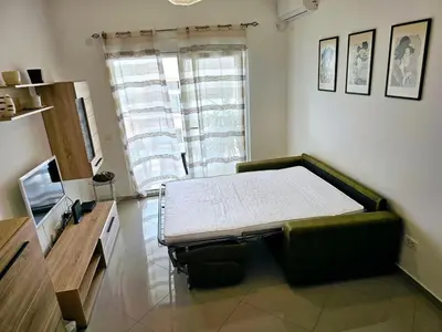 a room with a table and a couch in a room at Vi apartment 1lin of the sea in Bar
