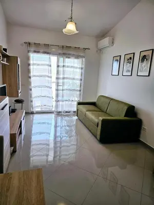 a living room with a couch and a large window at Vi apartment 1lin of the sea in Bar