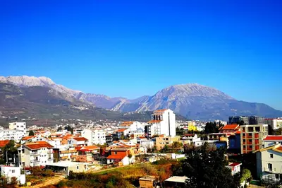 a view of a city with mountains in the background at Vi apartment 1lin of the sea in Bar