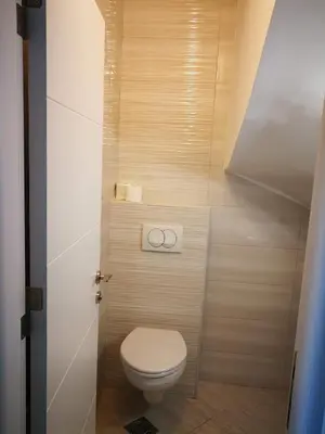 a bathroom with a toilet in a small room at Vi apartment 1lin of the sea in Bar