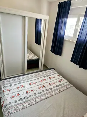 a bedroom with a bed with a mirror and a mirror at Vi apartment 1lin of the sea in Bar