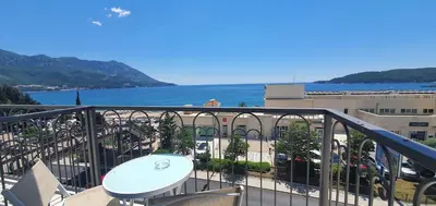 a balcony with a table and a view of the water at Hotel Svarog in Becici