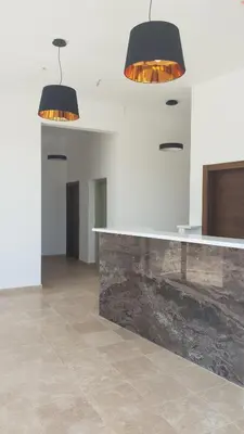 two lights hanging over a counter in a room at Hotel Svarog in Becici