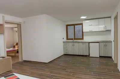an empty room with a kitchen and a living room at Leonida Resort in Donji Štoj
