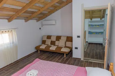 a living room with a couch and a chair at Leonida Resort in Donji Štoj