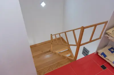a doll house with a wooden staircase in a room at Leonida Resort in Donji Štoj