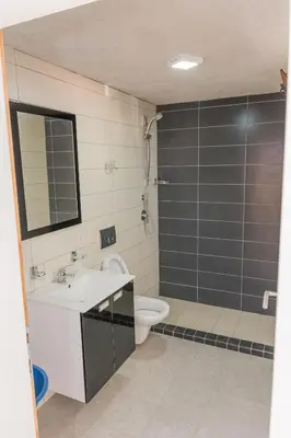 a bathroom with a shower and a sink and a toilet at Leonida Resort in Donji Štoj