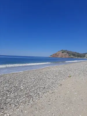 a rocky beach with the ocean in the background at 