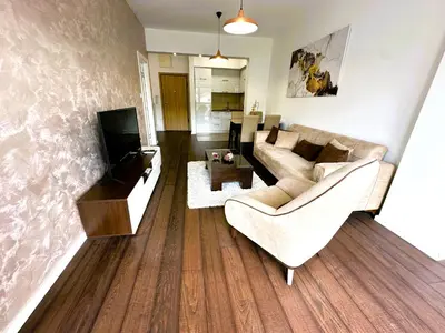 a living room with a couch and a tv at Stan na dan Podgorica in Podgorica