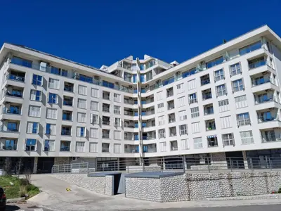 a large white apartment building with a lot of windows at Stan na dan Podgorica in Podgorica