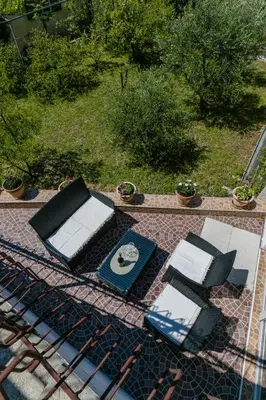 a group of chairs and tables on a patio at Apartments Feniks in Kotor