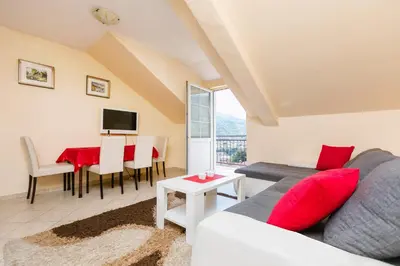 a living room with a couch and a table at Apartments Feniks in Kotor