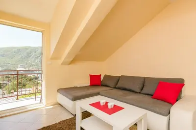a living room with a couch and a table at Apartments Feniks in Kotor
