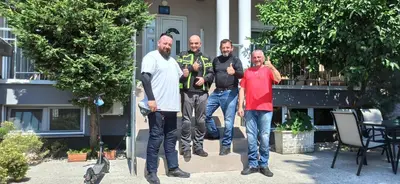 a group of men standing in front of a house at Apartment's Meti in Ulcinj