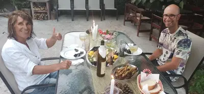 a man and a woman sitting at a table at Apartment's Meti in Ulcinj