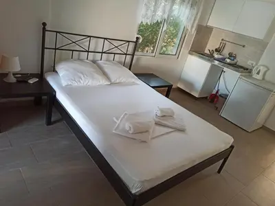 a bedroom with a bed with two towels on it at Apartment's Meti in Ulcinj
