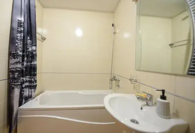a bathroom with a sink and a bath tub at Enigma in Podgorica