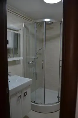 a shower with a glass door in a bathroom at Apartments TMV Dragovic in Sveti Stefan