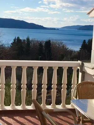 a balcony with a view of the water at Apartments TMV Dragovic in Sveti Stefan