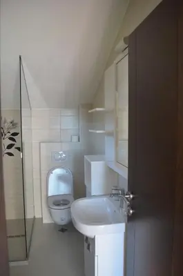 a small bathroom with a toilet and a sink at Apartments TMV Dragovic in Sveti Stefan
